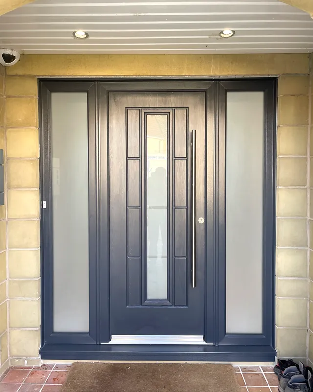 Dark composite Rock Door set in a stone porch entrance